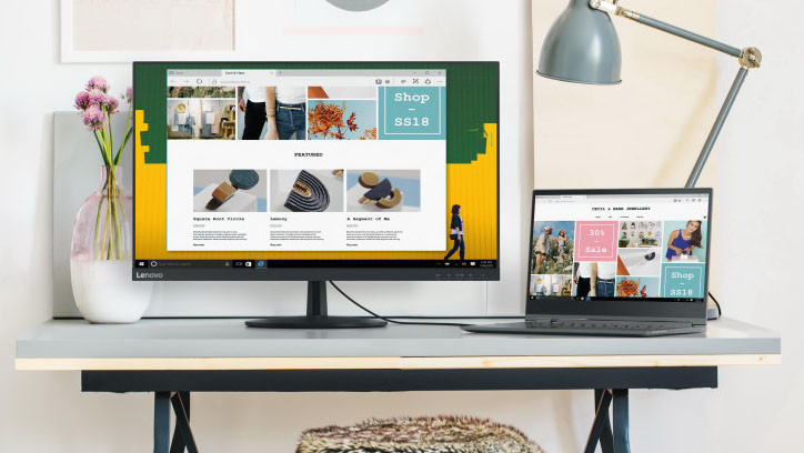Ein Homeoffice-Arbeitsplatz mit einem Monitor und einem Notebook. Die Wand im Hintergrund ist lebendig und bunt gestaltet, was dem Raum eine kreative und einladende Atmosphäre verleiht.